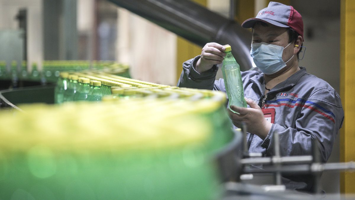 An employee works on the production line of the Swire Coca-Cola Beverages Hubei Limited on March 24 in Wuhan, China. The factory reopened March 15.