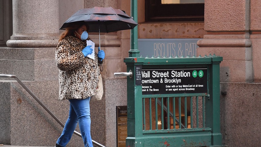 A woman walks by the Wall Street subway station in New York City